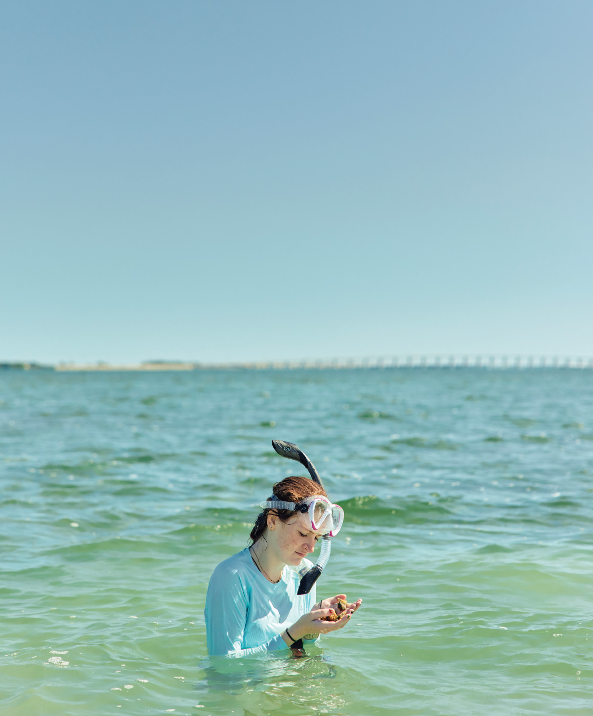 Leah Wysocki examining a sponge she has torn open.