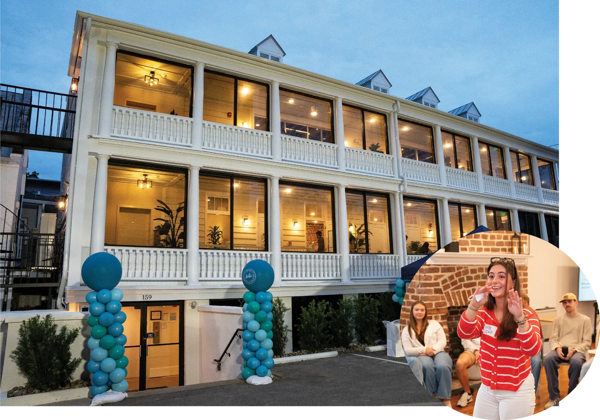 A two-story white building with wraparound porches is lit at dusk, decorated with teal balloon columns at the entrance, with an inset image showing a woman speaking to a seated audience inside.