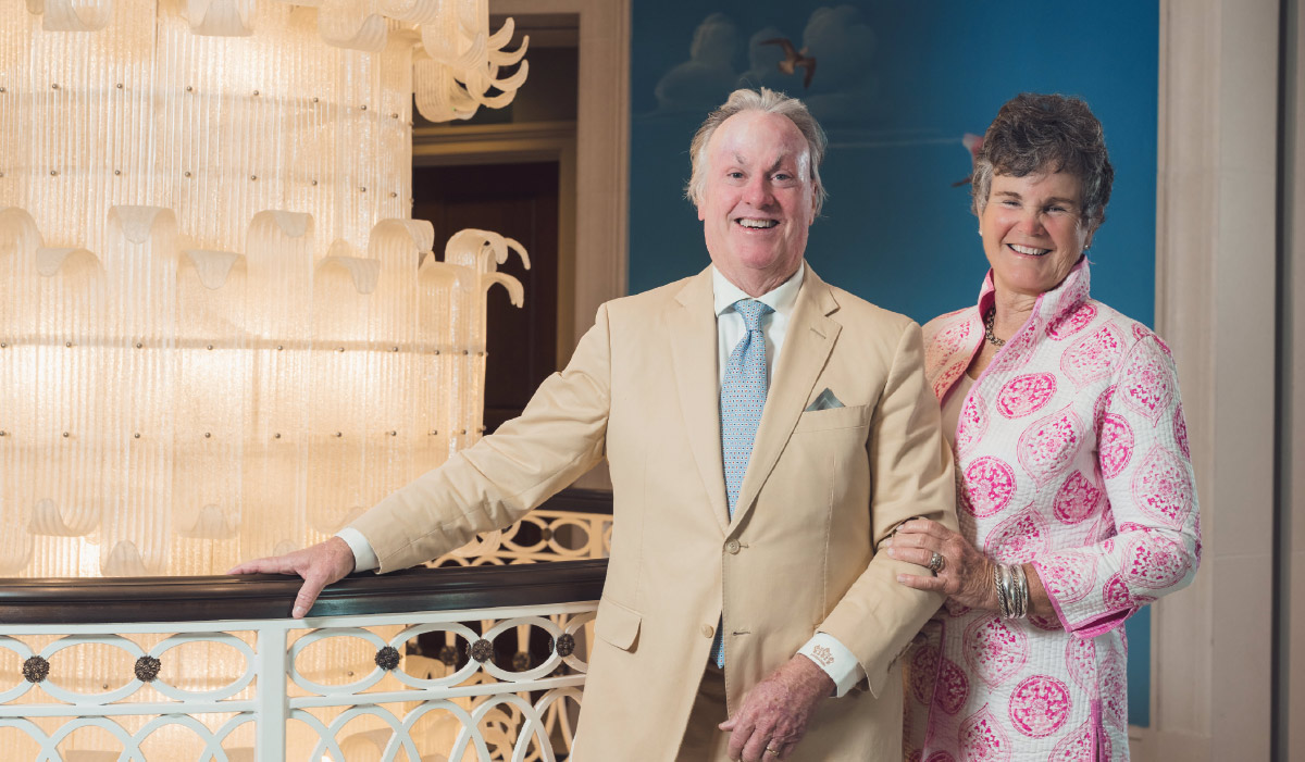 Amy Bennett standing next to Michael inside the Hotel Bennett with a hand resting on his arm