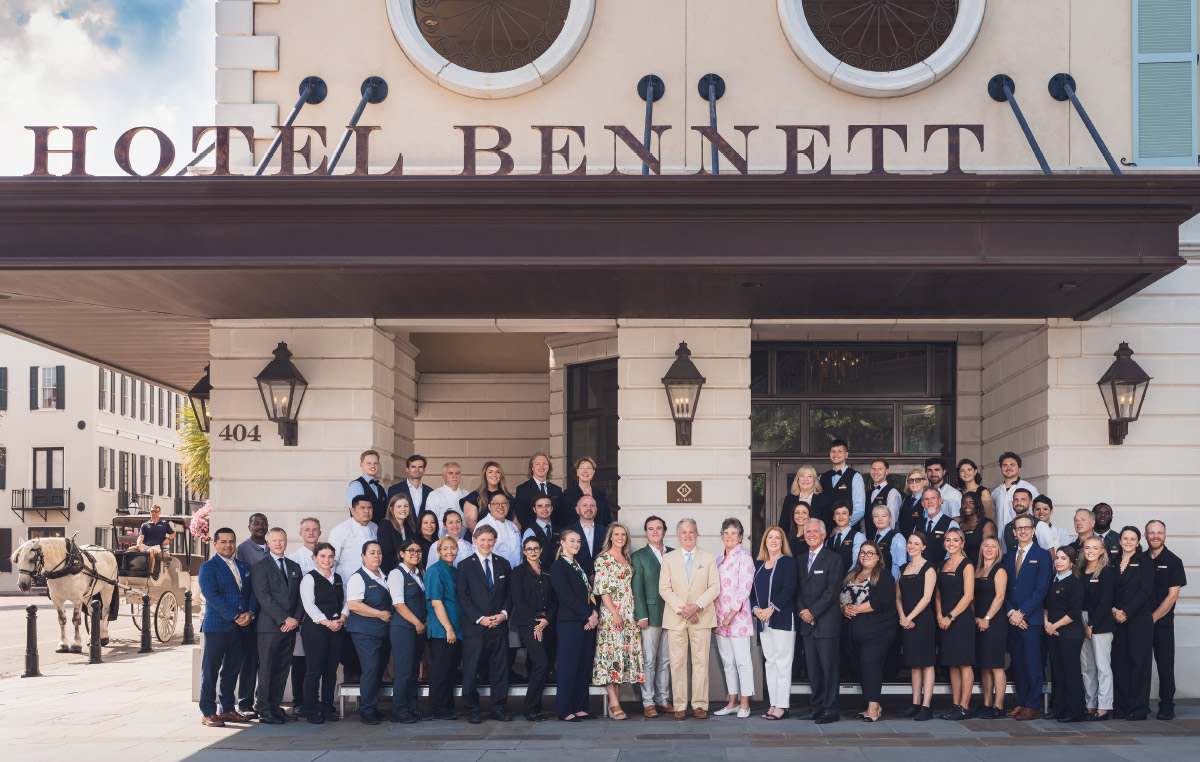 The Bennett family standing out front the building with the Hotel Bennett team
